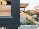 The home's cantilevered front balcony utilized pre-stained cedar to save money versus Shou Sugi Ban charred siding.  Photo 3 of 9 in Budget Breakdown: An Architect Couple Build a Net-Zero Home and Studio for $250 Per Square Foot
