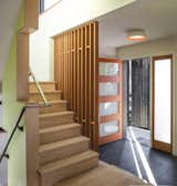 Although testing confirmed the home is as well-sealed as a certified Passive House, it's designed to be filled with light, including a frosted-glass front door and a stairway teeming with windows.  Photo 4 of 9 in Budget Breakdown: An Architect Couple Build a Net-Zero Home and Studio for $250 Per Square Foot