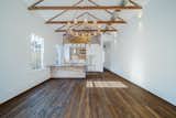 In the living room, the design team removed a drop ceiling to expose the vaulted roof, and they installed a simple prefinished pine floor.
