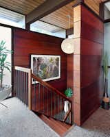 The stairway is a now showcase for the home’s old-growth redwood paneling.
