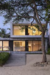 The Hansen Residence—also known as Modern Surf Shack or Casa Los Arboles—is a simple concrete construction, providing a robust envelope to withstand storms (the walls are double the thickness required by code). From the beach, stairs lead up to the main bedroom.