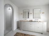 A custom bathroom vanity embraces and compliments the curve of the archways.