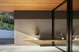 The foyer's Douglas fir-clad ceiling extends from the glass-walled foyer outward to form a covered entry.