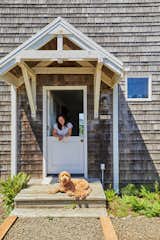 Doors on either side of the ground floor, including a Dutch door in front, fill the house with fresh air — much to the approval of Nora, the Milfords' Goldendoodle.  Photo 3 of 14 in Budget Breakdown: An Oregon Retreat Revamped for $135K Channels Nautical Wes Anderson Vibes