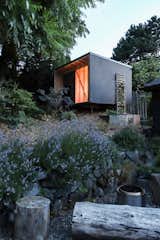 The Uphill Utilitarian sits at the back of a sloping site, which the owners left as natural as possible, while adding a small seating area.