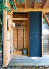 The shed's garden-storage space opens outward, with the door itself doubling as storage.