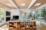 The living room was expanded in a previous renovation, further cantilevering toward the trees.  Photo 8 of 15 in Skylight by Frankie Beloz from Listed at $2M, a Hollywood Hills Midcentury Hovers in a Sycamore Canopy