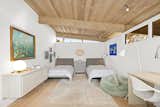 A second bedroom  is full of light thanks to the clerestory windows above.  Photo 12 of 13 in A Santa Monica Midcentury by a Late Actor Turned Architect Lists for $3.15 Million