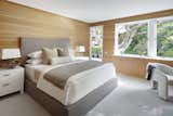 The principal bedroom looks out onto the garden, continuing the palette of Douglas fir paneling.
