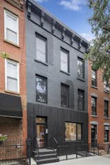 The ground floor, previously altered by a past owner to make room for a restaurant, was clad in charred wood siding.  Photo 2 of 11 in A Punched-Up Brooklyn Townhouse Holds Three New Condos Starting at $1.2M