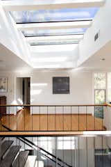 A skylight over the stairway creates an atrium-like volume and fills the home with natural light.