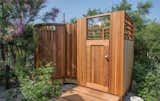 The yard includes an outdoor shower with an enclosed dressing room.