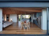 With the doors and sliding glass wall both open, the home takes advantage of the breeze to remain cool.