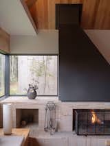 This fireplace occupies the corner and provides varying geometries to visually enhance the space.