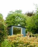 The window perfectly frames the landscape outside, a protected natural area.