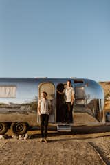 Nate Kantor and Garrett Foster Green stand in front of Anza, the 1968 Airstream camper they renovated.