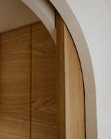 The bathroom's solid-oak door slides into a pocket, allowing natural light from the bathroom window to fill the space.