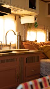 The couple made thorough use of Path Design's saved scrap-wood pieces to create custom cabinetry.  Photo 7 of 17 in Budget Breakdown: A Woodworker Couple Make $10K Go the Distance Renovating a 2006 Camper