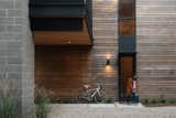 The house's modest entrance leads one up the stairs to an unfolding panoramic view.  Photo 5 of 14 in A Floating Living Room Sets a Family’s Lake Michigan Cottage Apart From the Rest