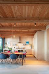 The great room includes oak floors as well as birch cabinetry and wall panels, all treated with a whitening wash to help spread natural light.  Photo 12 of 75 in Plywood by Thomas Albrecht from A Floating Living Room Sets a Family’s Lake Michigan Cottage Apart From the Rest
