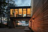 While much of the non-water-facing side of the main house includes few windows, the living room acts as a glowing beacon.