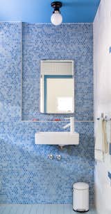 The bathroom was enlivened with a wall of hexagonal blue Pratt &amp; Larson tile.