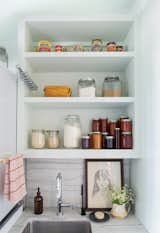 Additional pantry storage and a second sink in the relocated laundry area