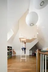 Hung from ceiling rafters, the treehouse allows the playroom's ground floor to remain open.