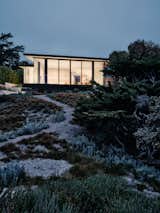 The architects envisioned entry-facing and beach-front sides like an analog camera's viewfinder and wide-angle lens, with the rammed-earth-clad central interior wall leading the way.  Photo 4 of 13 in A California Retreat Has Walls Made Out of the Beach