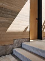 Limestone flooring and wainscotting underscore the rammed-earth walls.  Photo 10 of 13 in A California Retreat Has Walls Made Out of the Beach