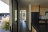One continuous hallway goes across the house, from carport to great room to bedrooms. It allows the house to be expanded with an identically-designed twin, simply extending the hallway.
