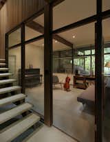 The guest room and music room on the ground floor, though tucked under the upstairs deck, gets natural light from both sides,