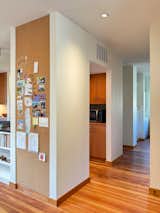 Where the living room and hallway meet the kitchen, a built-in cork board was added.