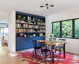 The new dining room, at the clients' request, was kept distinct from the kitchen just behind it, which also provided room for additional shelving. Architect Michael Howells co-designed the rug.