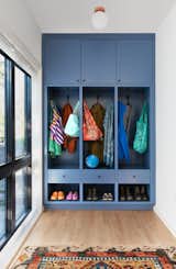 Also in the foyer, beside a wall of glass that brings light into the living/dining area, is storagefor coats, bags and shoes.