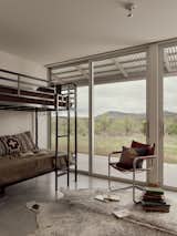 Both bedrooms, including this bunk room, feature the same sliding-glass doors as the living room and great room, allowing plenty of natural light.