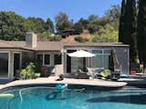 The existing house's outdoor patio came with a pool the family used frequently, but the lack of a roof overhang above the glass patio doors and clerestory windows often created glare inside.