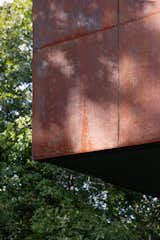 The house is clad primarily with weathered steel.