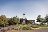 Architect Tom Kundig of Olson Kundig envisioned the home slowly disappearing into its landscaped setting, amidst trees and folliage.