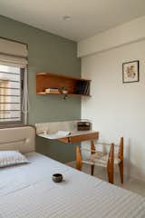 The guest room, where Abhishek's father likes to read, includes a custom chair designed by Abhishek's partner, Jeet Gajera.