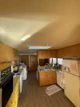 The kitchen felt cut off from the rest of the house, and despite its skylight (filtered by a frosted acrylic lower panel), seemed dark.