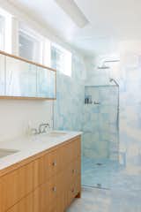 In the main bathroom, new wood cabinetry, quartzite countertops and clerestory lights help brighten the space.
