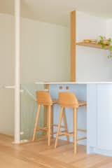 The upper portion of wall between the basement stairway and the kitchen was removed and its lower half replaced with glass, creating more openness between the basement and upstairs.