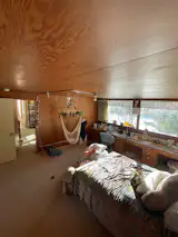 The family loved the second bedroom for its plywood walls, ceiling panels and built-in desk. But the room felt dark, and the ceiling panels were sagging.