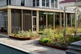 The meadow is close enough to the glass-walled dining room and kitchen (and screen porch) that the homeowners can feel immersed in nature even while inside.