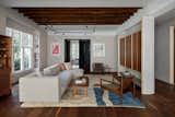 In the living room, the ceiling rafters were exposed, with their holes and rough texture left untouched.