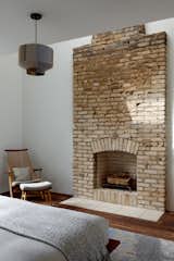 A fireplace in the primary bedroom, mostly hidden in the wall before renovation, was fully exposed and partially rebuilt, brick by brick.