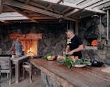 With a fireplace, pizza oven and Argentine grill as well as a sheltering awning, the outdoor kitchen has become the heart of the home.