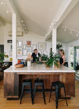 The renovated kitchen feels much more spacious thanks to its removed walls. The large kitchen island is clad with salvaged redwood that Brandon found waiting to be burned on a roadside.