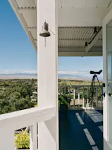 The outdoor lanai offers panoramic views, while the house's higher elevation keeps temperatures relatively cool.